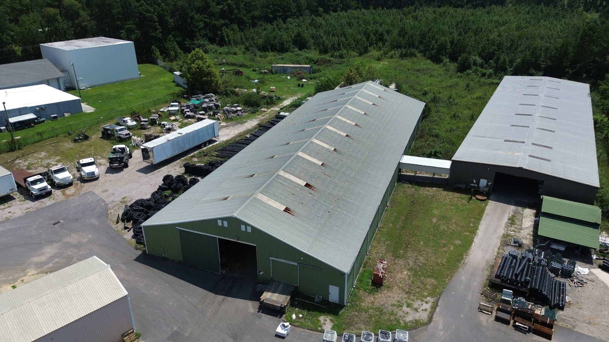 large commercial building before metal roof coating project aerial view